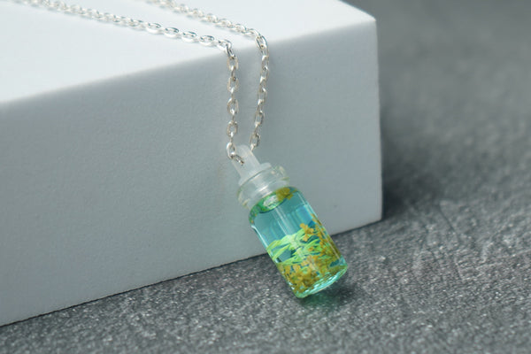 Yellow Annes lace real flower in small bottle pendent