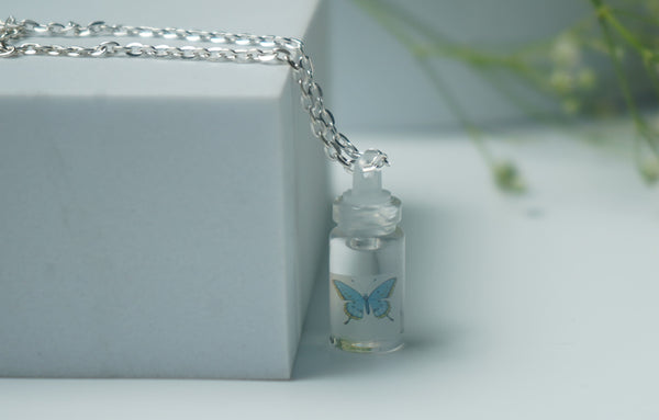 Butterfly  in small bottle pendent